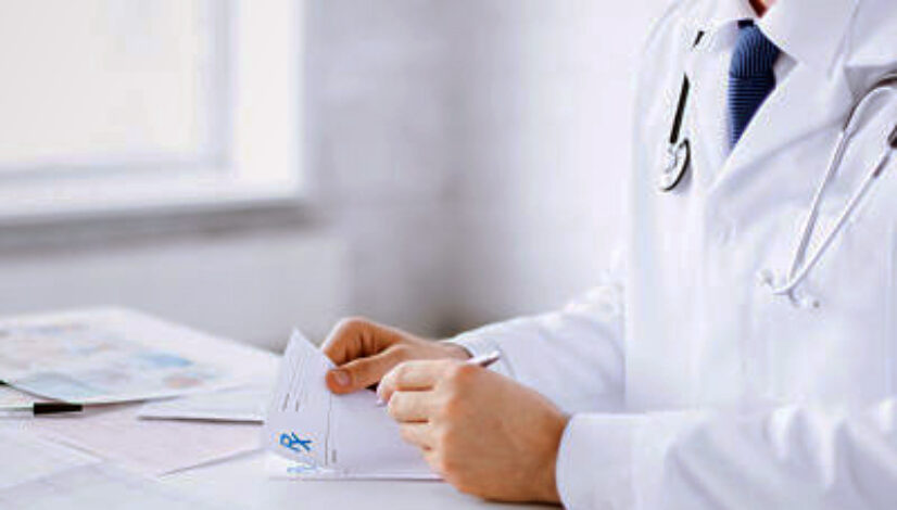 male doctor writing prescription paper