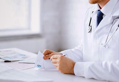 male doctor writing prescription paper